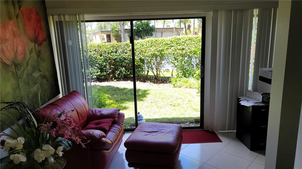 6574 Burning Wood Drive, Unit 101 Boca Raton, FL 33433 - Photo 13 of 25 a living room with furniture and a large window