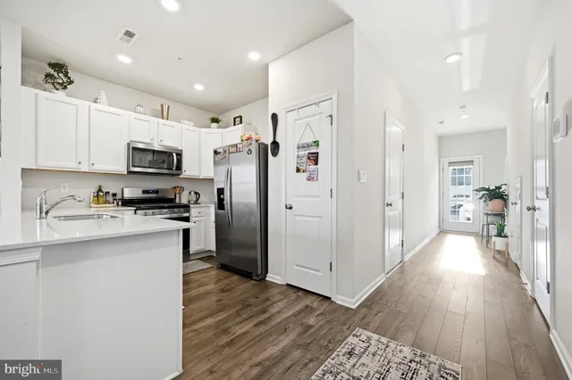 a kitchen with stainless steel appliances a refrigerator stove microwave and cabinets
