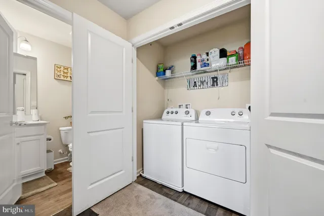 a utility room with sink dryer and washer