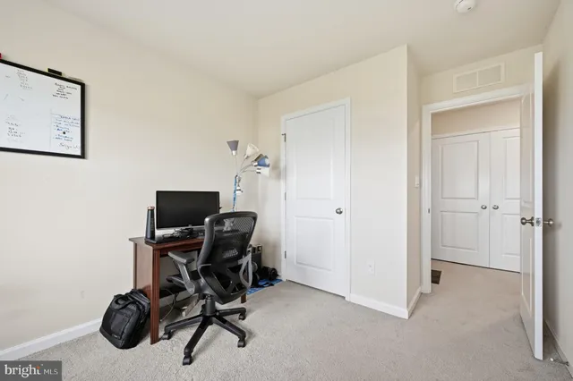 a view of a workspace with furniture and gym cycle