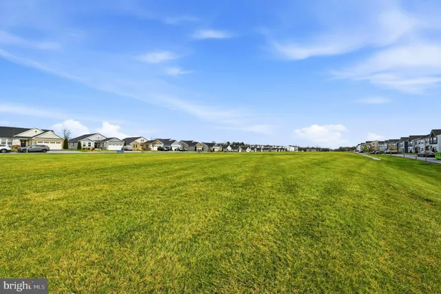 a view of yard with swimming pool outdoor seating and yard in back