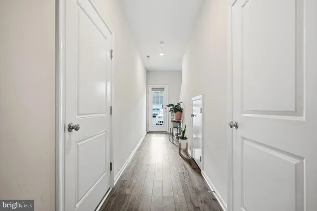 a view of hallway with wooden floor