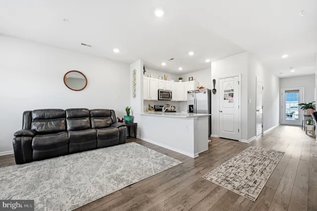 a living room with a couch and a wooden floor