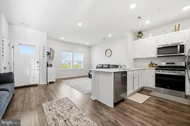 a kitchen with a refrigerator and a stove top oven