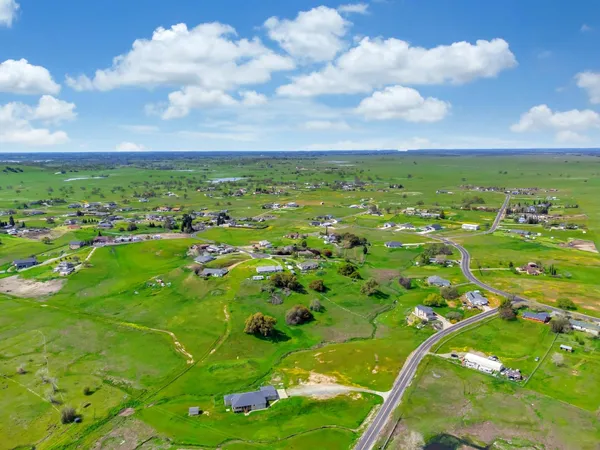 a view of a street with next to a yard