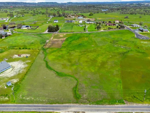 a view of a big yard with lots of green space