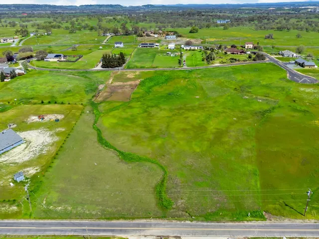 a view of a big yard with lots of green space