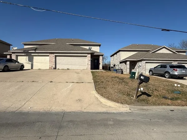 a front view of a house with parking area