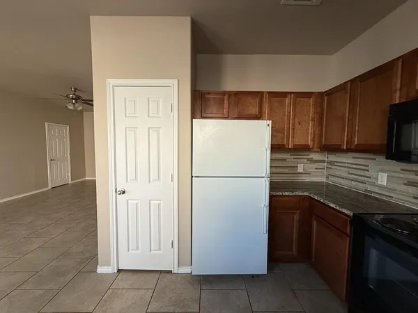 a white refrigerator freezer sitting in a kitchen