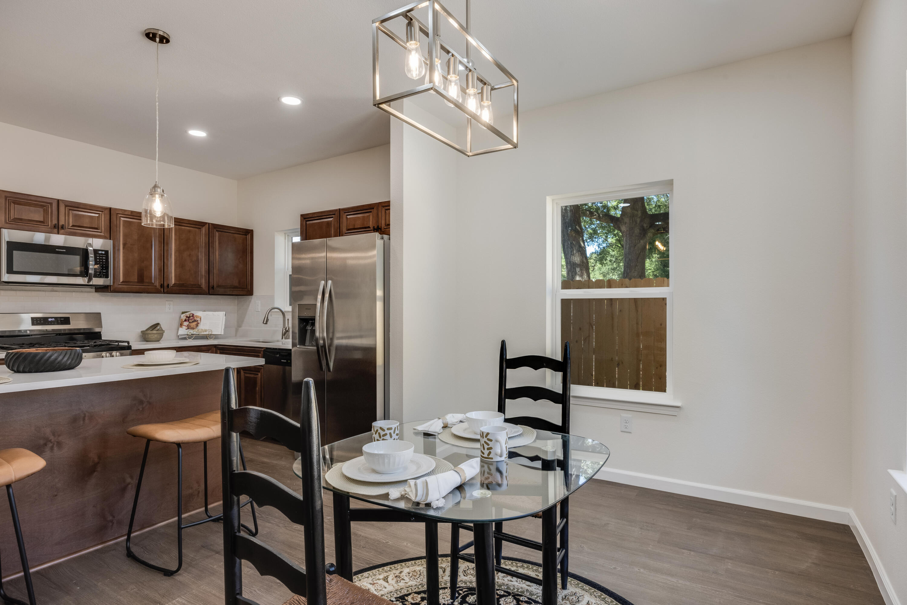 751 Amos Street, Unit A AND B Crestview, FL 32539 - Photo 13 of 47 a kitchen with kitchen island a dining table chairs stainless steel appliances and cabinets
