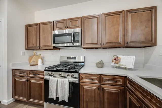 a kitchen with stainless steel appliances granite countertop a refrigerator and a sink