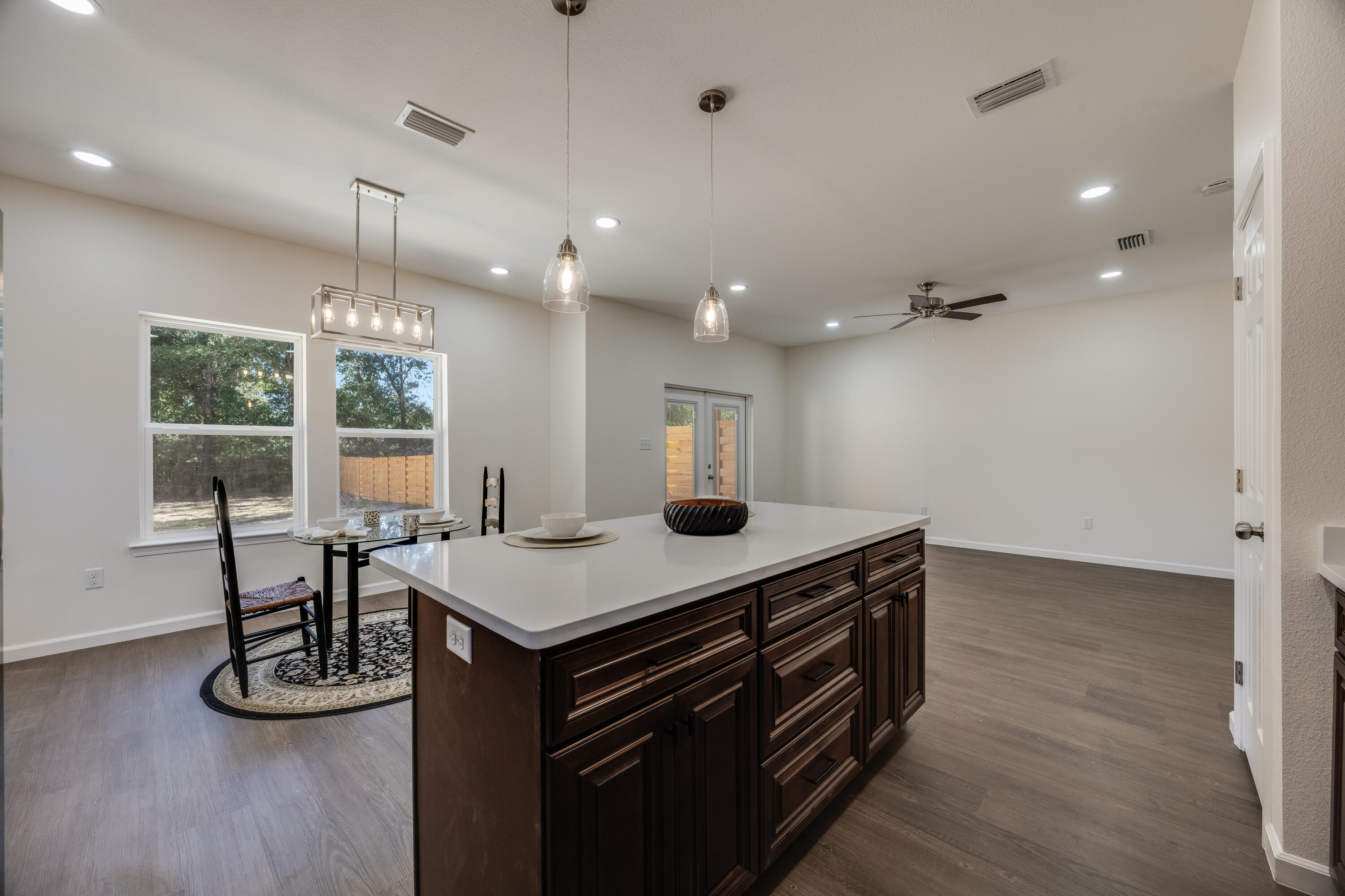 751 Amos Street, Unit A AND B Crestview, FL 32539 - Photo 22 of 47 a kitchen with a table chairs and wooden floor