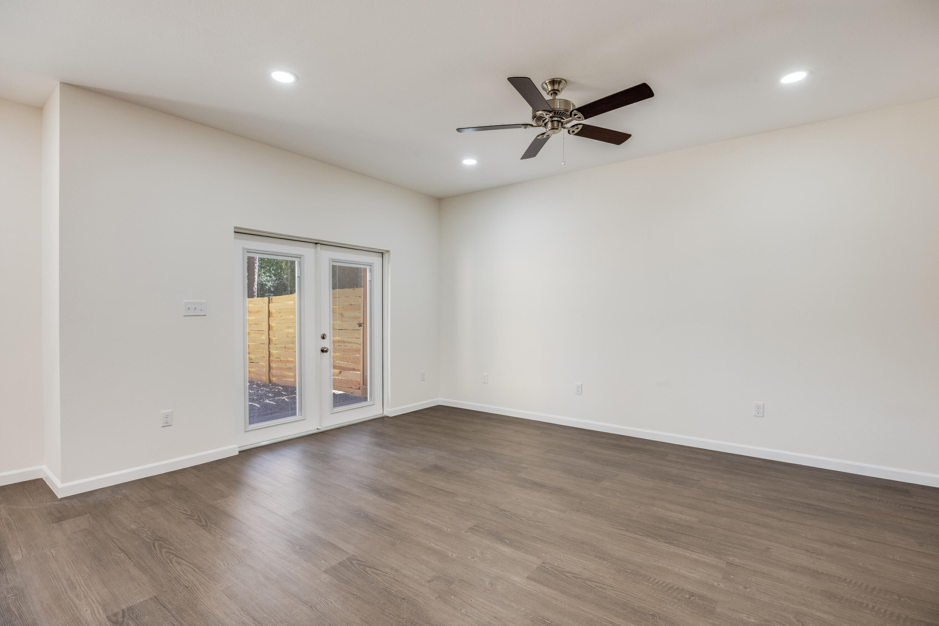 751 Amos Street, Unit A AND B Crestview, FL 32539 - Photo 9 of 47 a view of an empty room with wooden floor and a ceiling fan