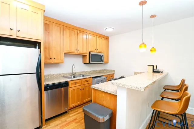 a white refrigerator freezer and a stove sitting inside of a kitchen