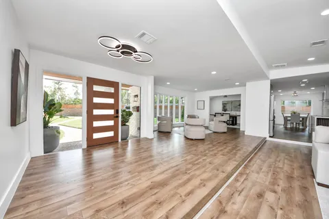 a view of a livingroom with furniture wooden floor and windows