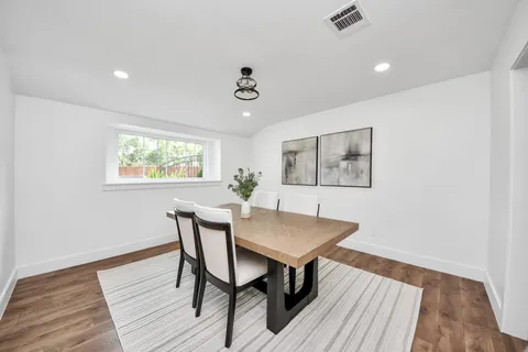 a view of a dining room with furniture window and wooden floor