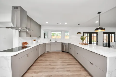 a large kitchen with stainless steel appliances lots of counter space sink and cabinets