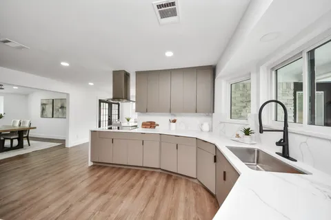 a kitchen with stainless steel appliances a sink and cabinets