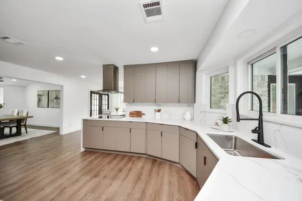 a kitchen with stainless steel appliances a sink and cabinets