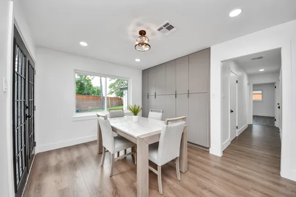 a view of a dining room with furniture window and wooden floor