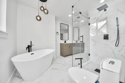 a bathroom with a sink a toilet and shower