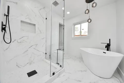 a bathroom with a bathtub and shower