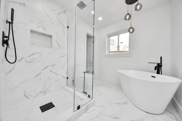a bathroom with a bathtub and shower