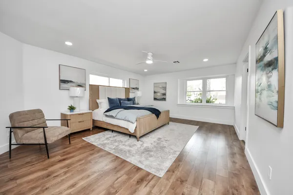 a bedroom with a bed and a chair