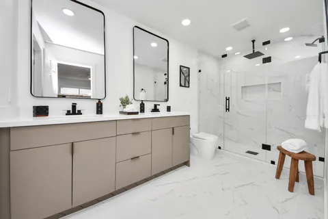 a bathroom with a double vanity sink mirror double shower and a bathtub