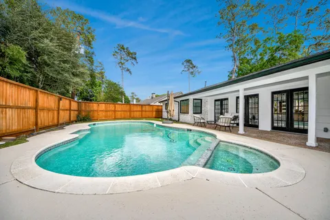 a view of backyard with swimming pool