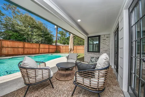 a view of a patio with couches chairs and a fire pit