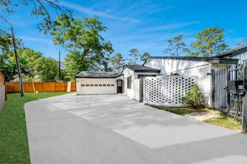 a view of a house with a yard and a garage