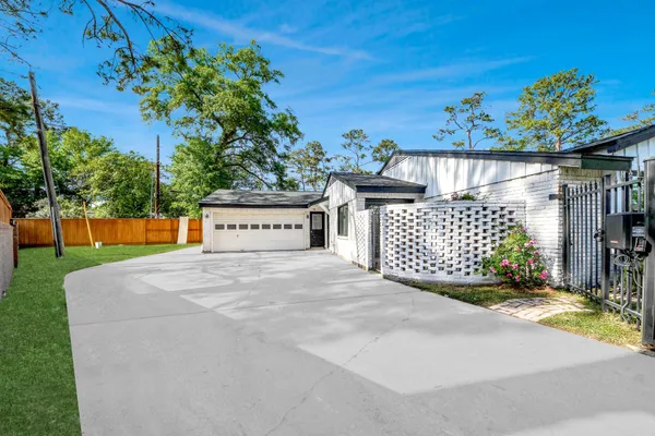 a view of a house with a yard and a garage