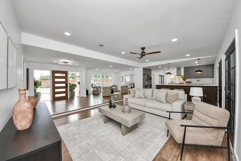 a living room with furniture and wooden floor