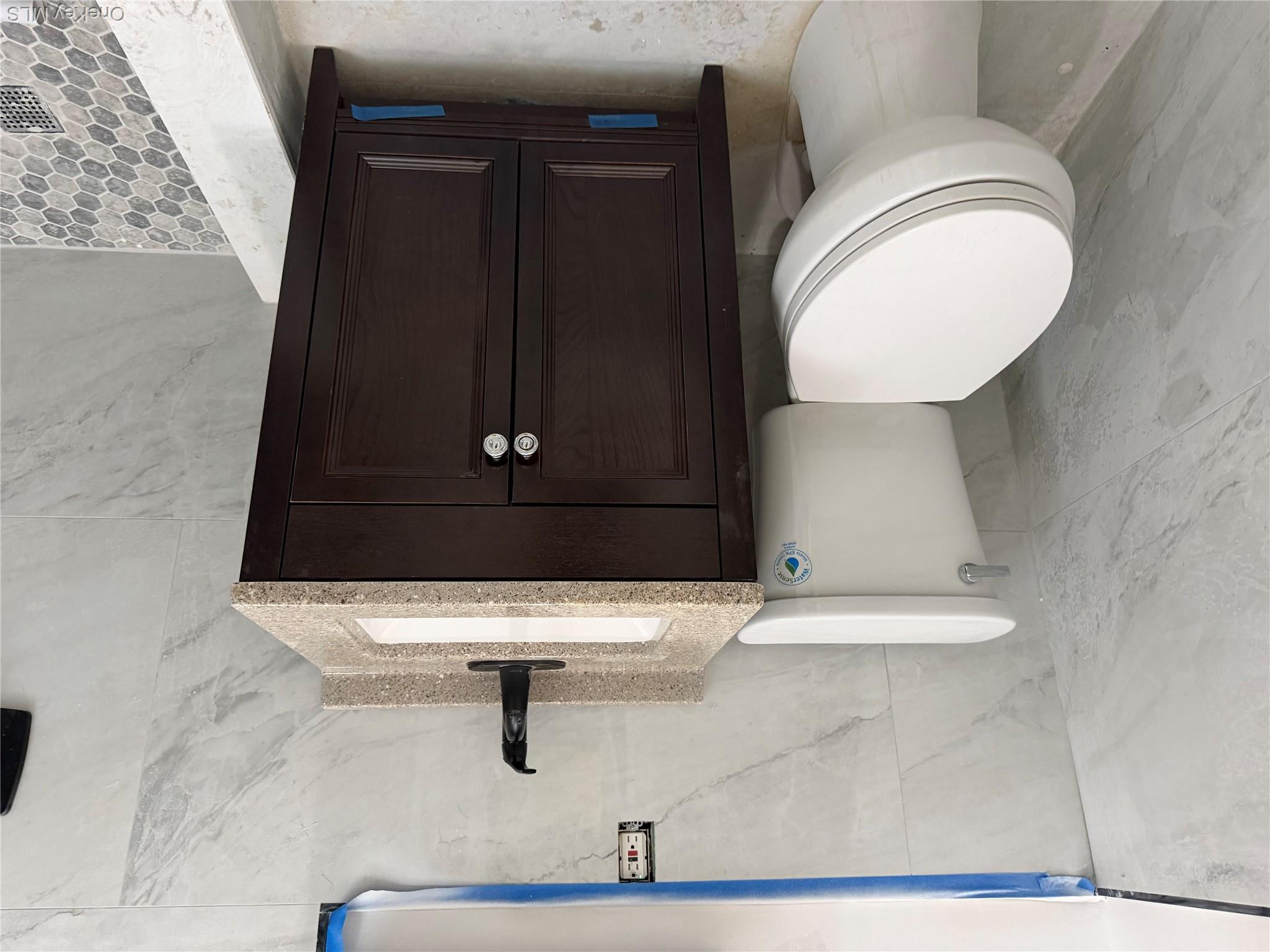 70 Howard Avenue Brooklyn, NY 11221 - Photo 6 of 8 a bathroom with a sink a toilet and shower