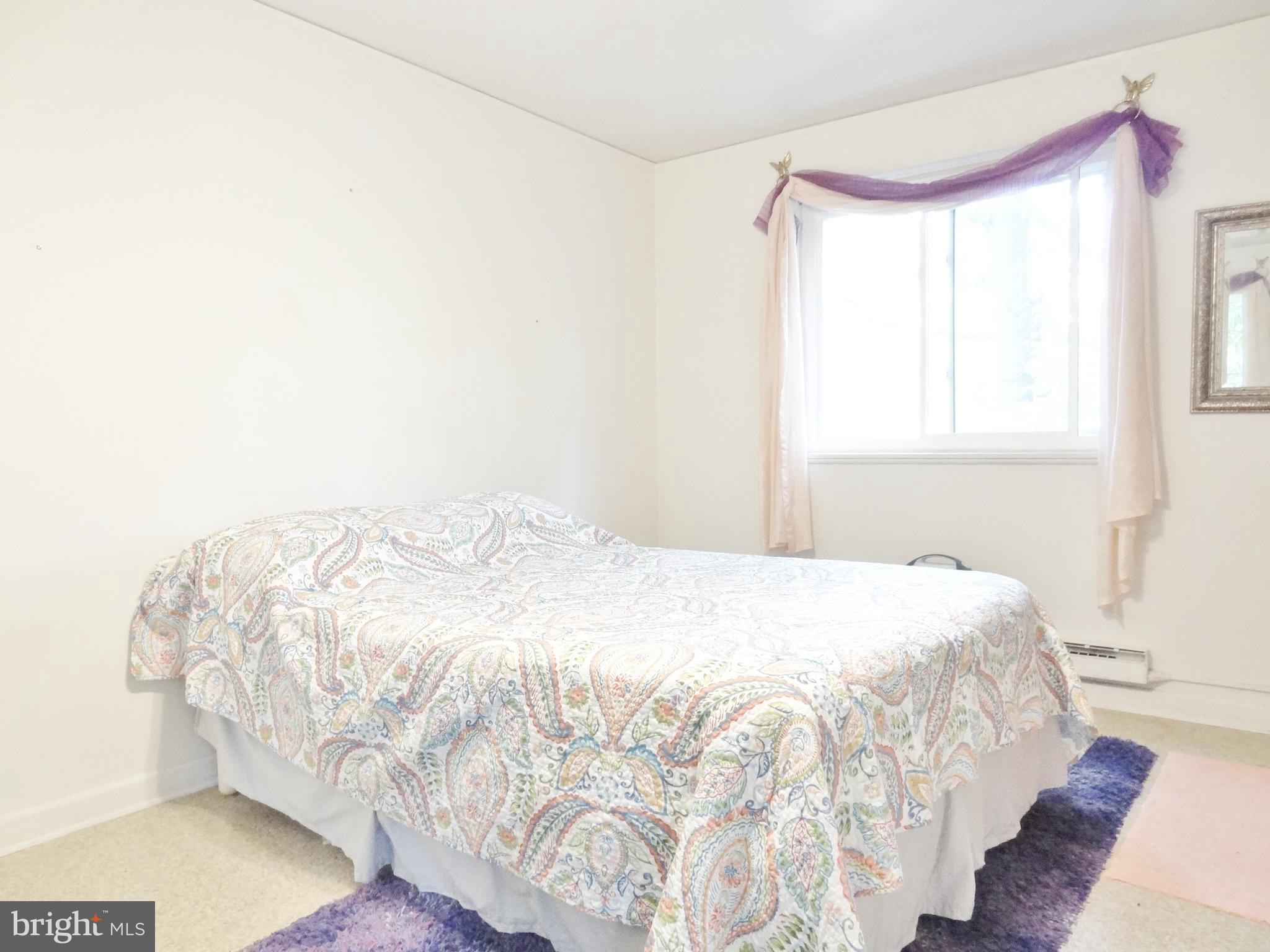 39 Ridge Road, Unit L Greenbelt, MD 20770 - Photo 8 of 15 a bedroom with a bed and a window