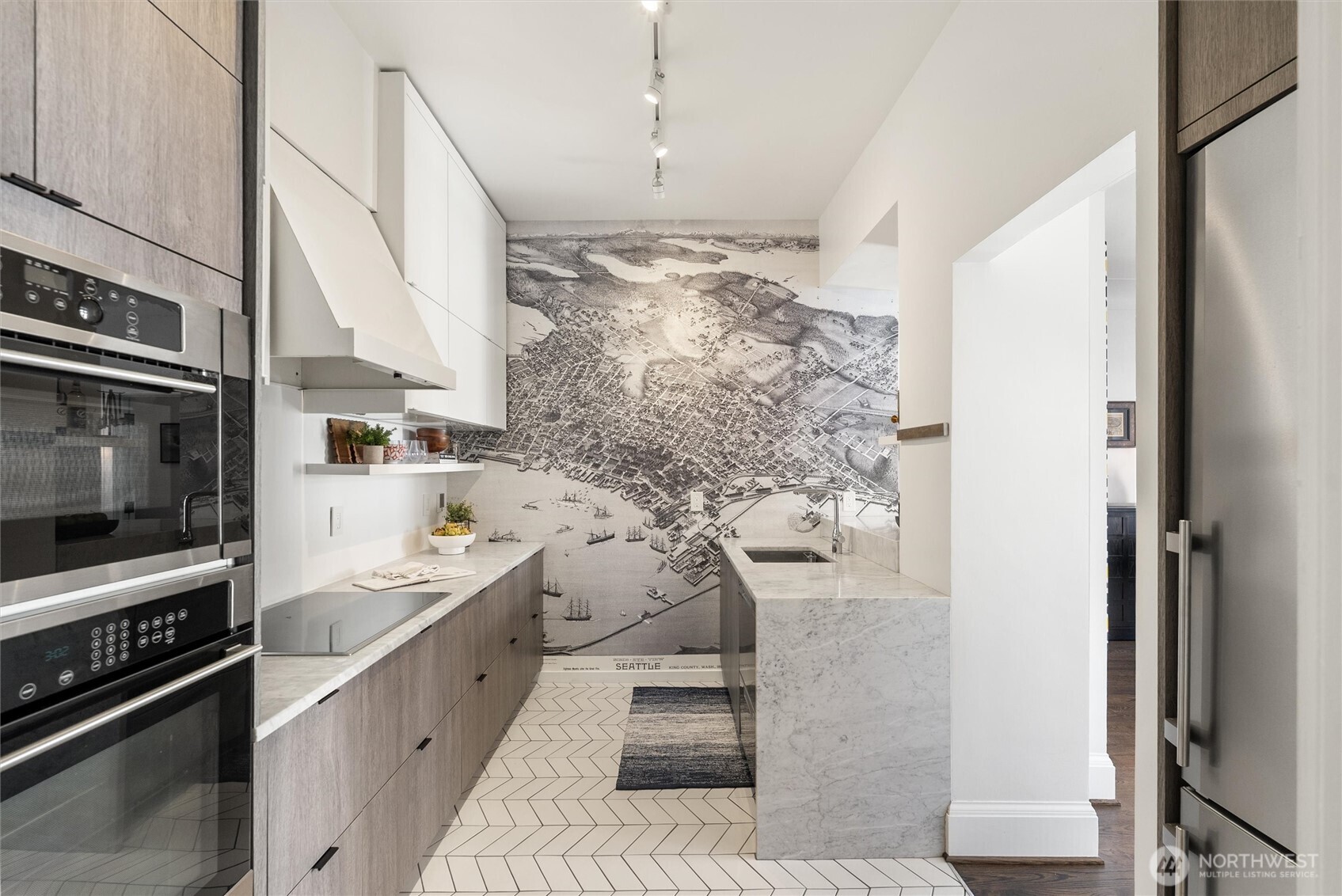 1519 3rd Avenue, Unit 501 Seattle, WA 98101 - Photo 11 of 37 a kitchen with stainless steel appliances kitchen island granite countertop a stove and a refrigerator