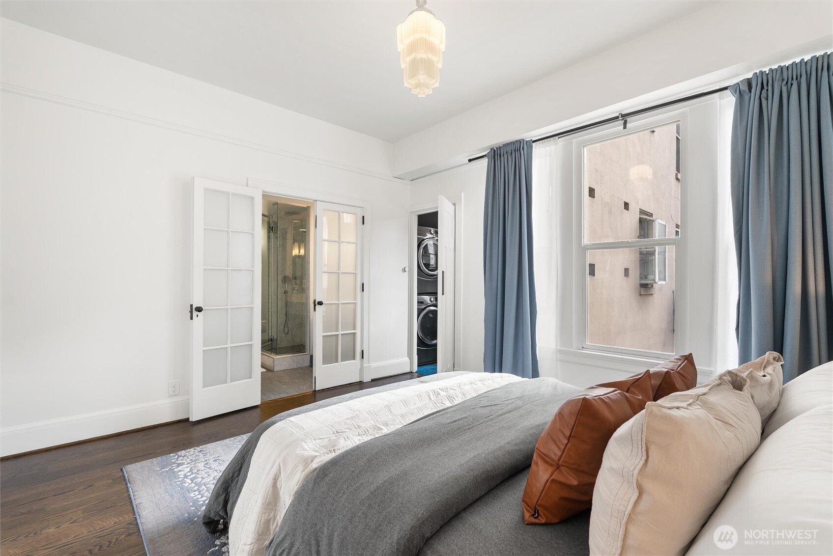 1519 3rd Avenue, Unit 501 Seattle, WA 98101 - Photo 17 of 37 a bedroom with a bed mirror and a window
