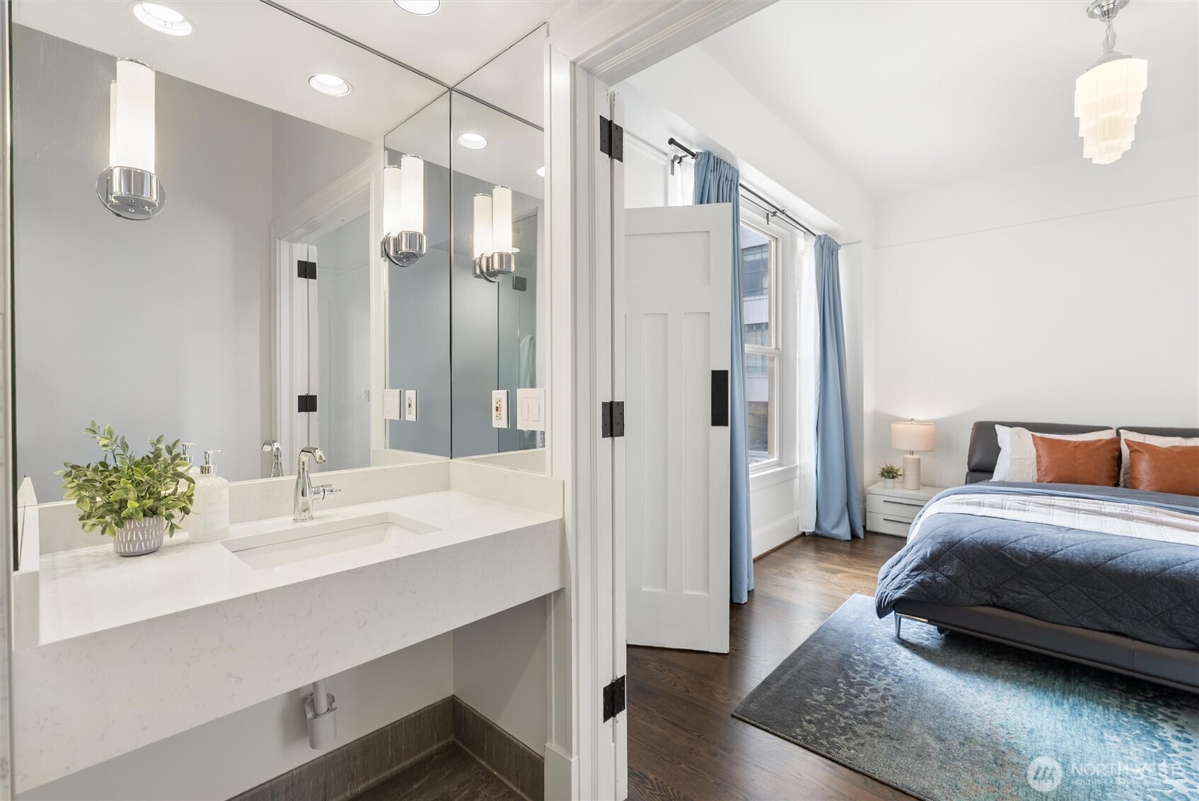 1519 3rd Avenue, Unit 501 Seattle, WA 98101 - Photo 20 of 37 a en suite bathroom with a double vanity sink a mirror and shower