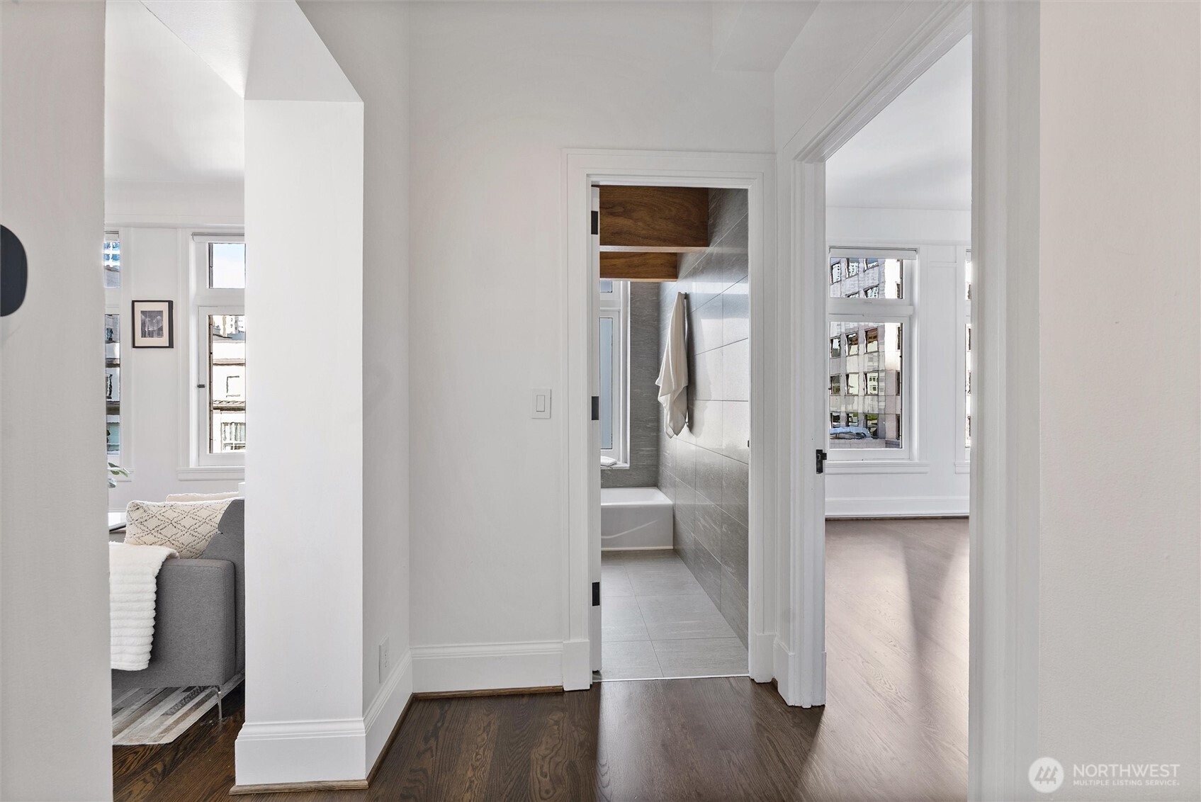 1519 3rd Avenue, Unit 501 Seattle, WA 98101 - Photo 32 of 37 a view of a hallway with bathroom and wooden floor