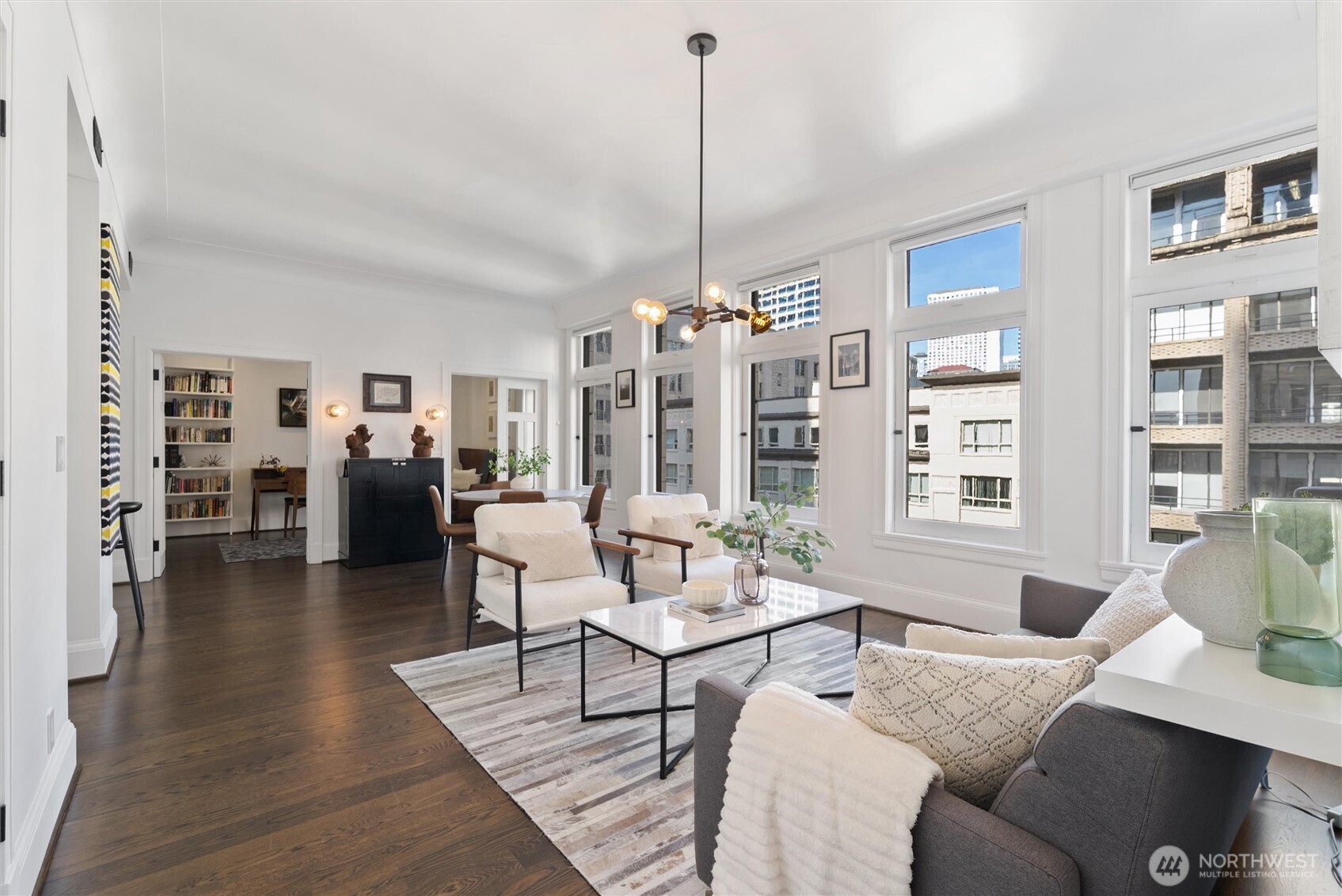 1519 3rd Avenue, Unit 501 Seattle, WA 98101 - Photo 4 of 37 a living room with furniture and a chandelier