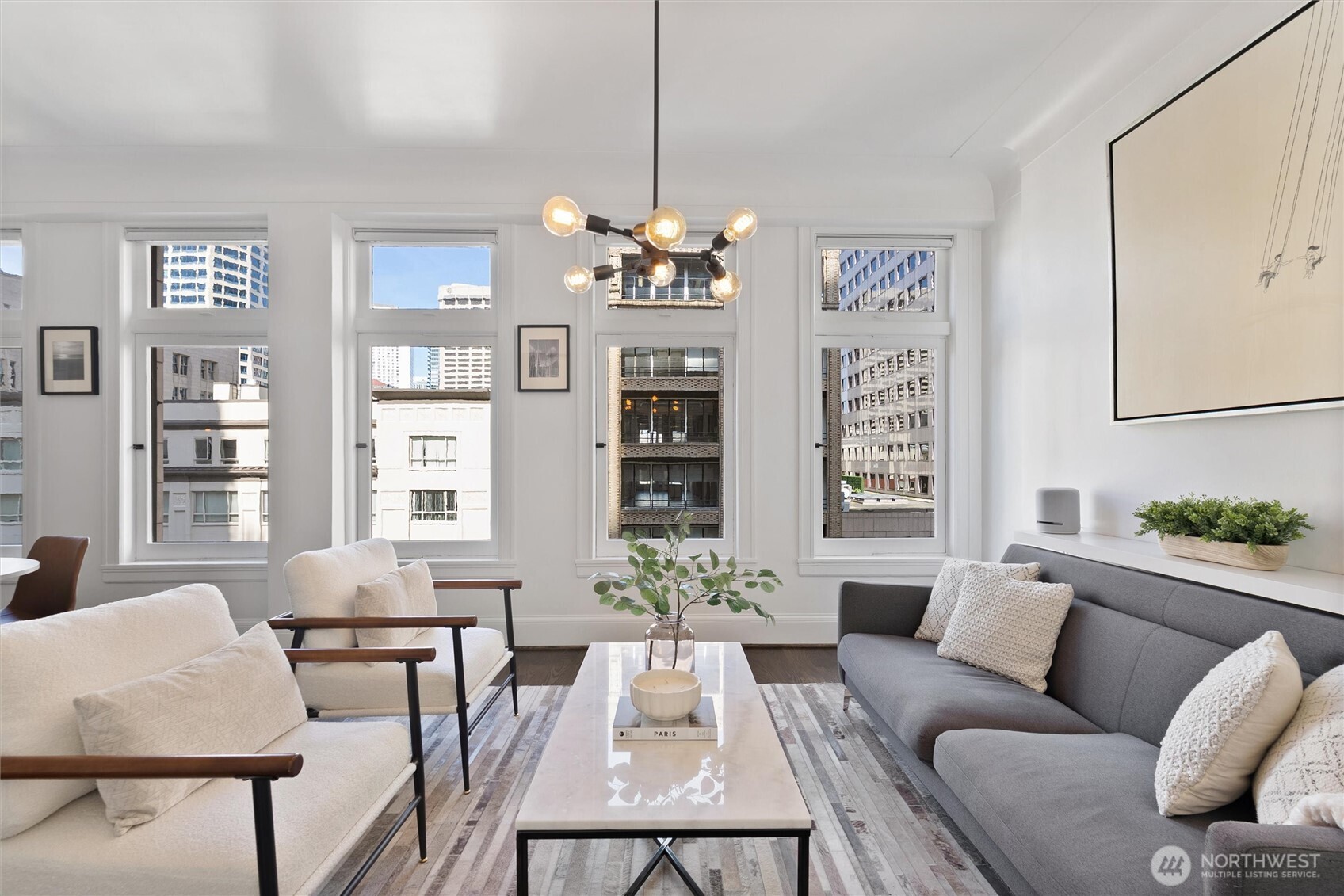 1519 3rd Avenue, Unit 501 Seattle, WA 98101 - Photo 5 of 37 a living room with furniture dining table and a chandelier