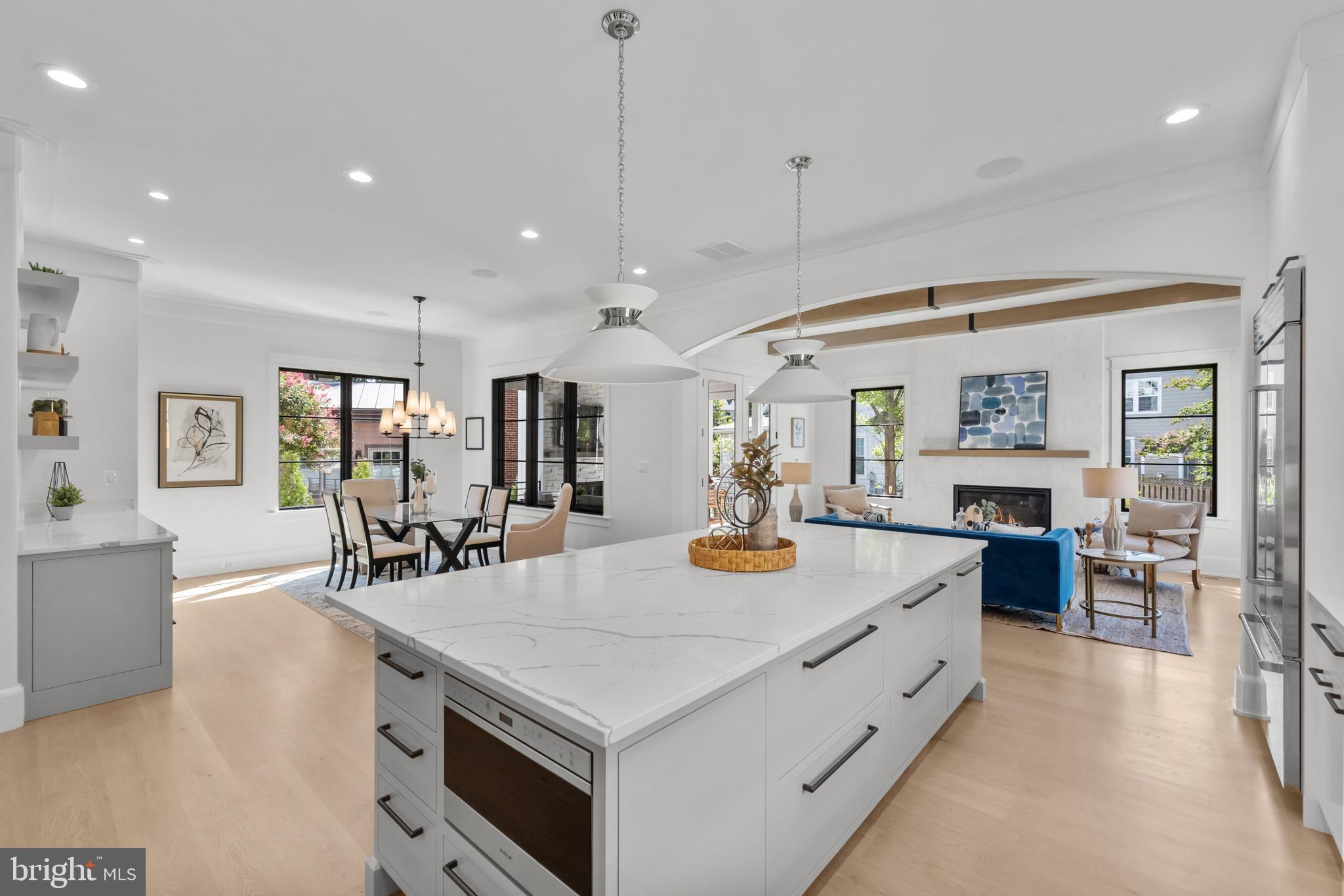 3108 Key Boulevard Arlington, VA 22201 - Photo 13 of 44 a large kitchen with kitchen island a stove a sink a dining table and chairs