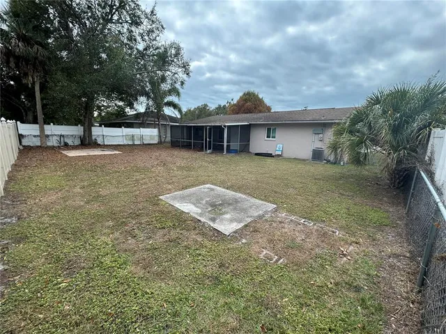 a view of a house with a backyard