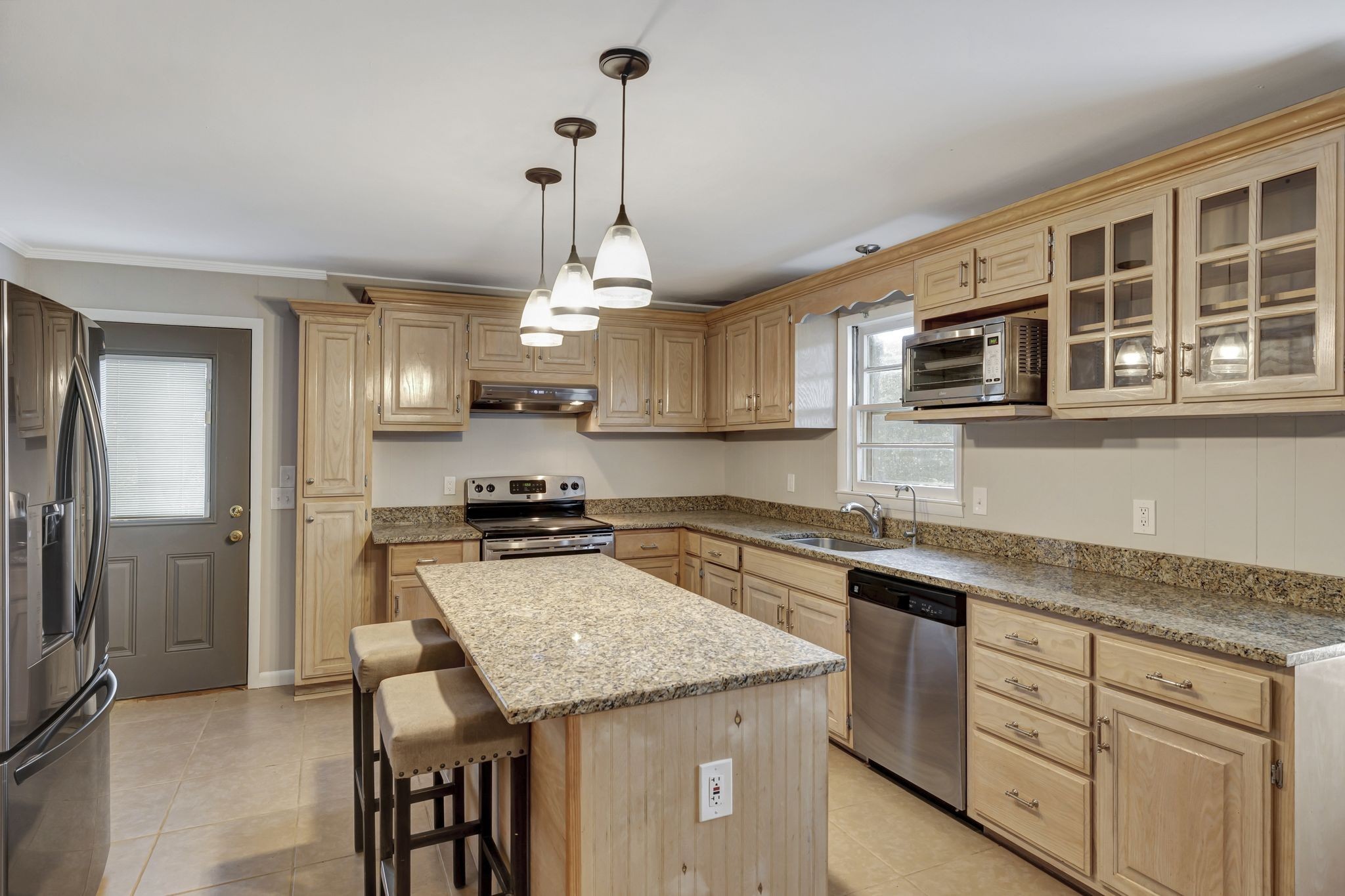2538 Ragsdale Road Columbia, TN 38401 - Photo 8 of 35 a kitchen with granite countertop stainless steel appliances a stove sink microwave and refrigerator