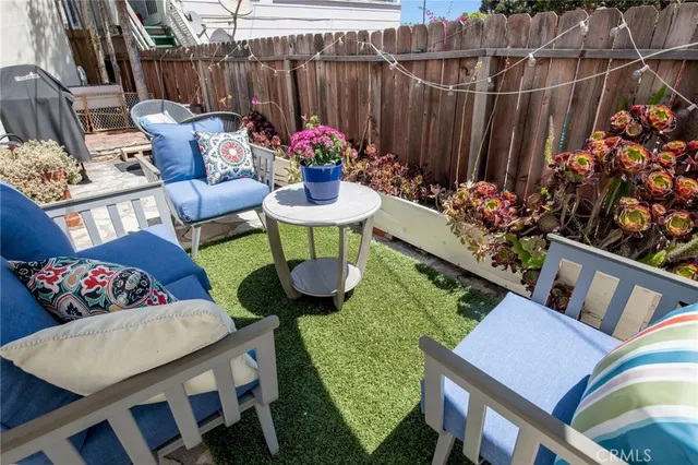 a outdoor dining space with furniture and flowers