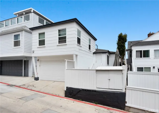 a view of a white house with large windows