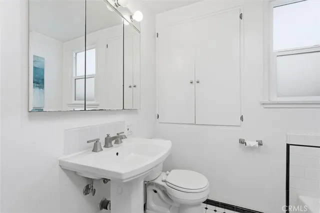 a bathroom with a sink toilet and vanity