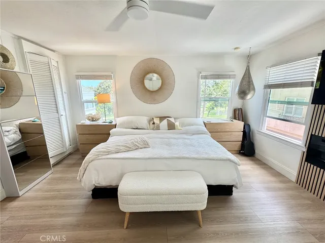 a bedroom with a bed and wooden floor