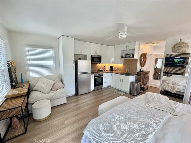 a living room with furniture and a kitchen view